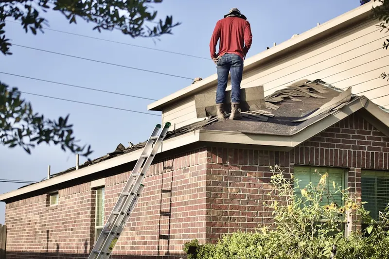 Professional roofer working on a residential roof in Chestnut Log